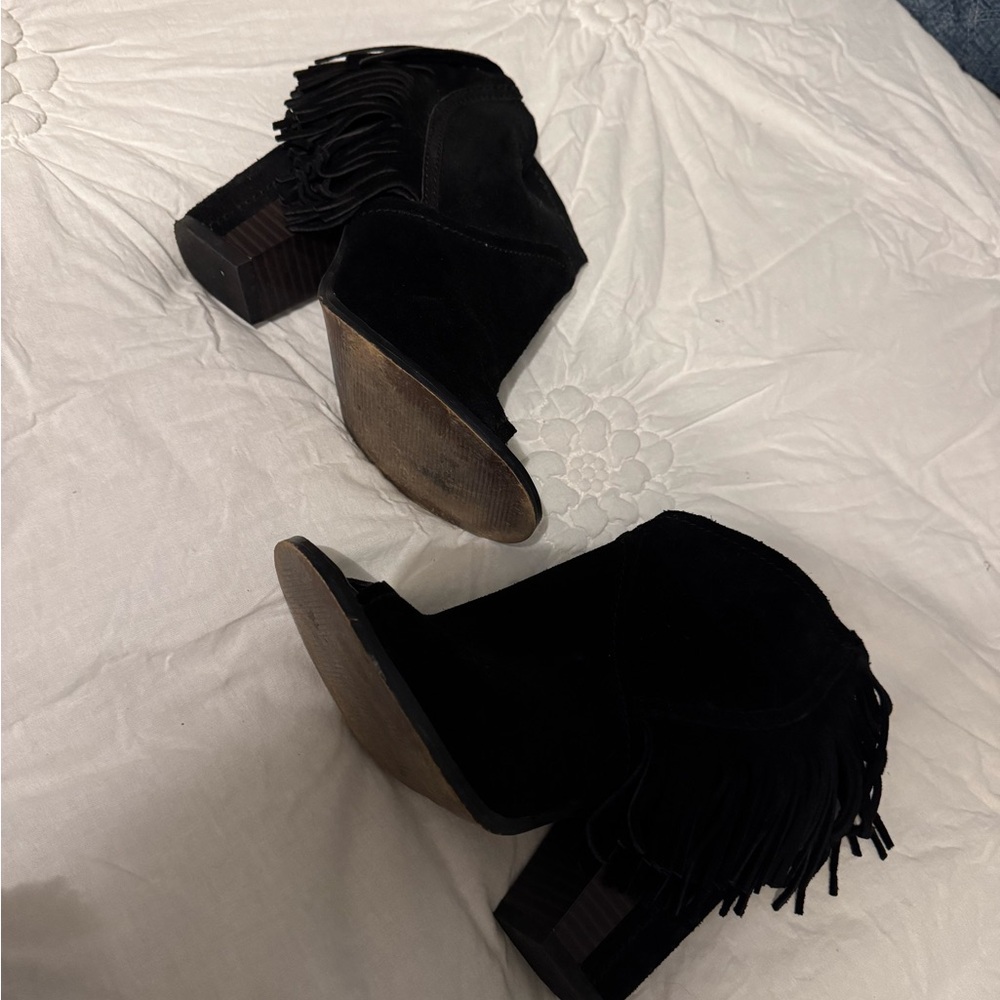 Black suede booties with side fringe.